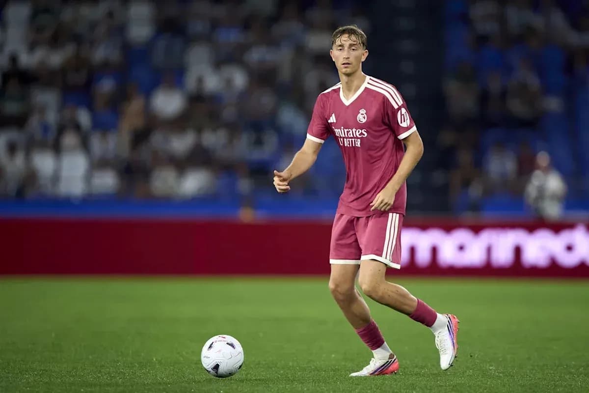 Player in pink kit controlling the ball on field