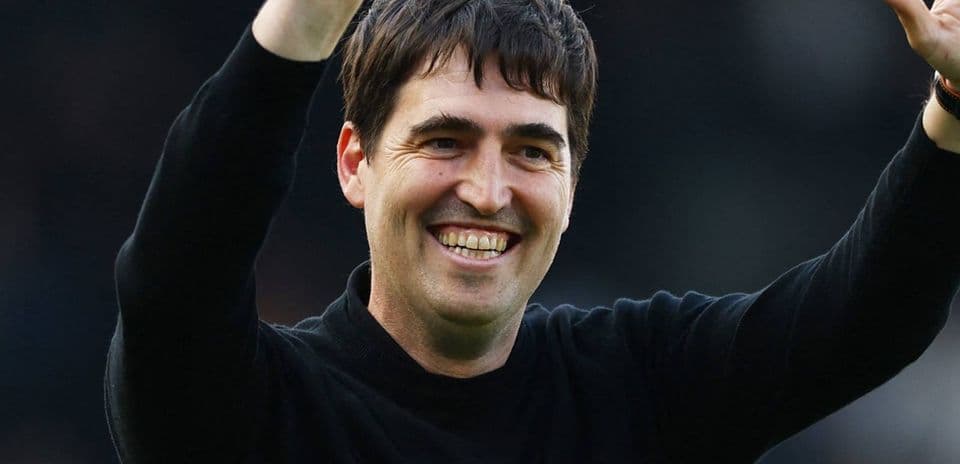 Coach celebrating with raised hands during match