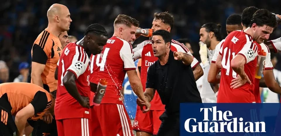 Arsenal players receiving instructions from the coach