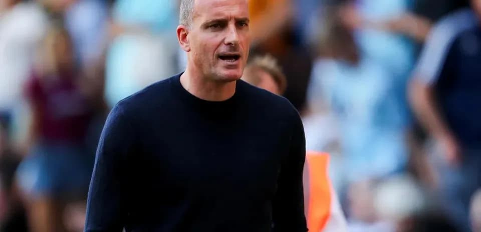 Coach speaking on the sidelines during a match