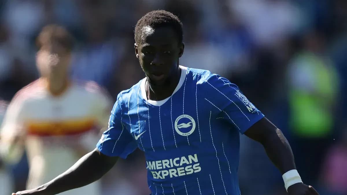 Player in blue kit dribbling the ball on pitch