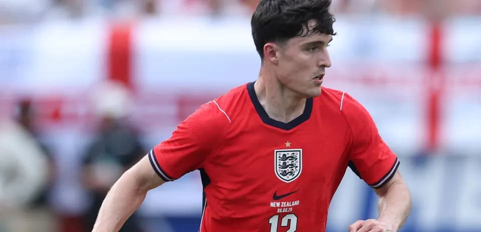 Player in red England jersey during match action