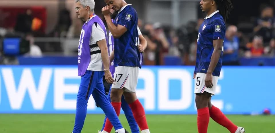 Player being assisted off field during match