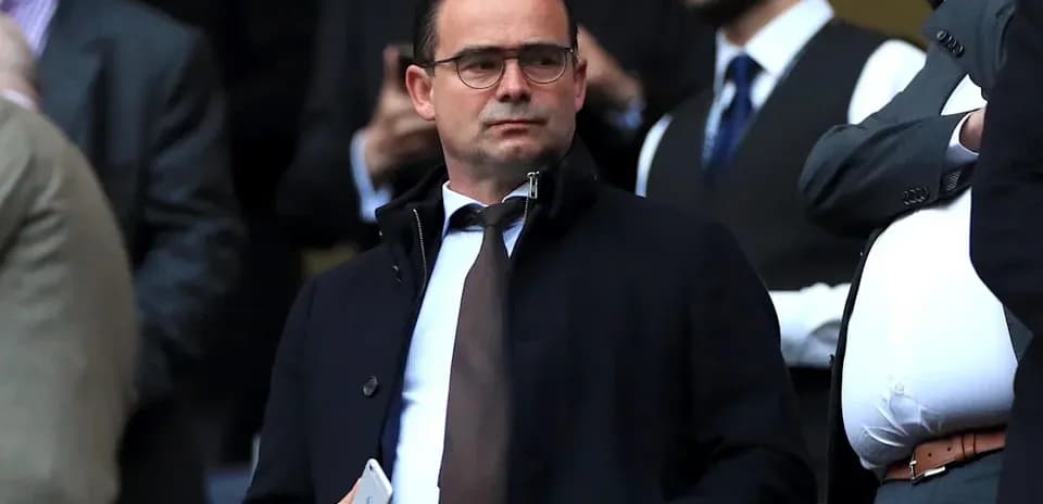 Man in suit observing event from the stands
