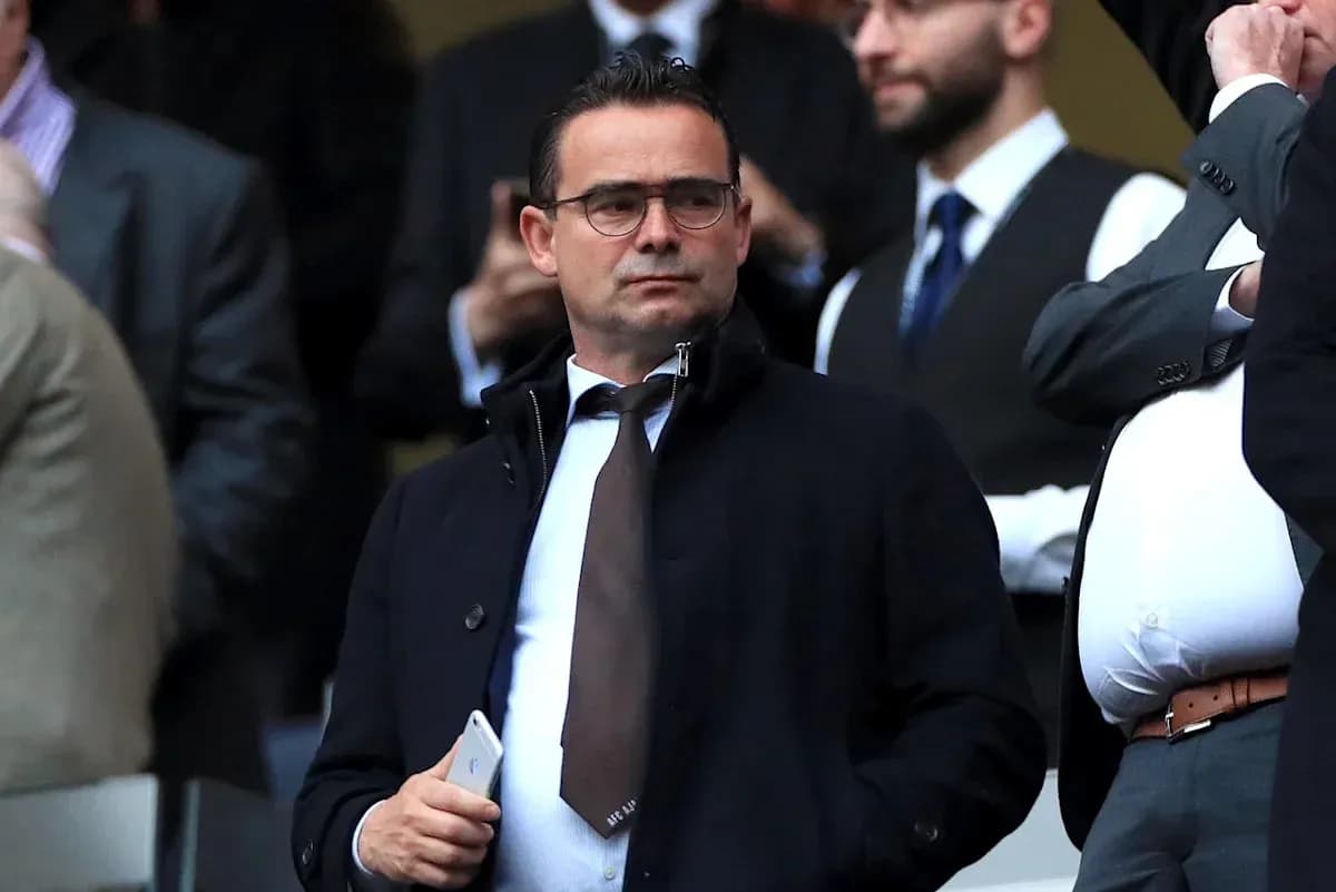 Man in suit observing event from the stands