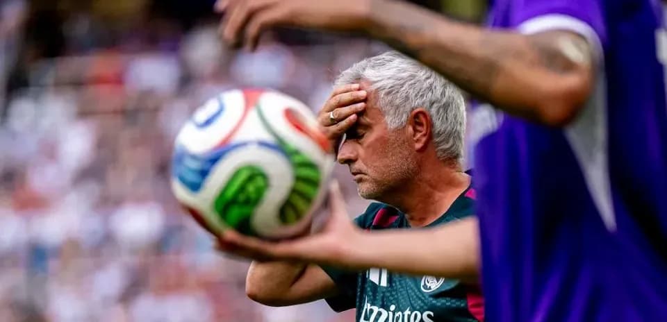 Manager holding forehead during match with ball