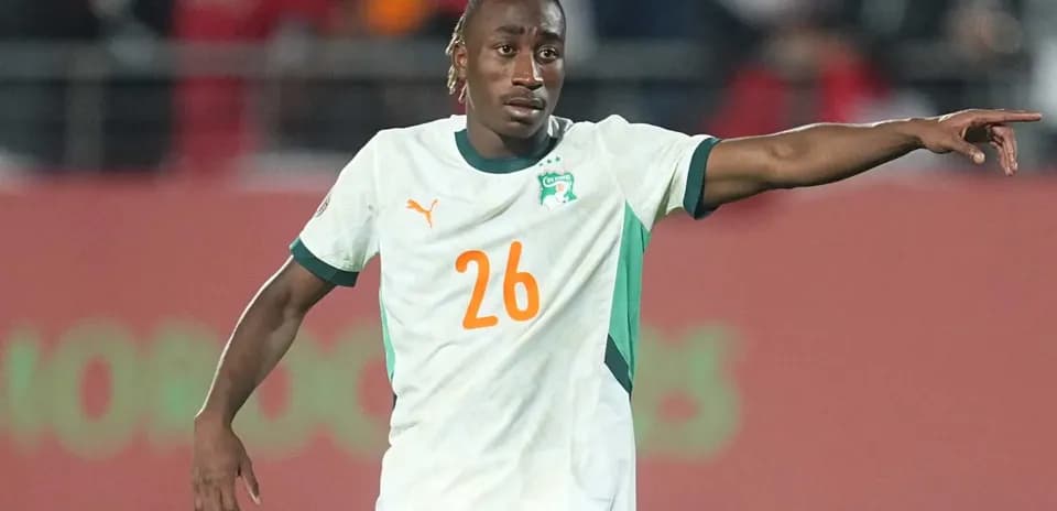 Player wearing Ivory Coast jersey gestures during match