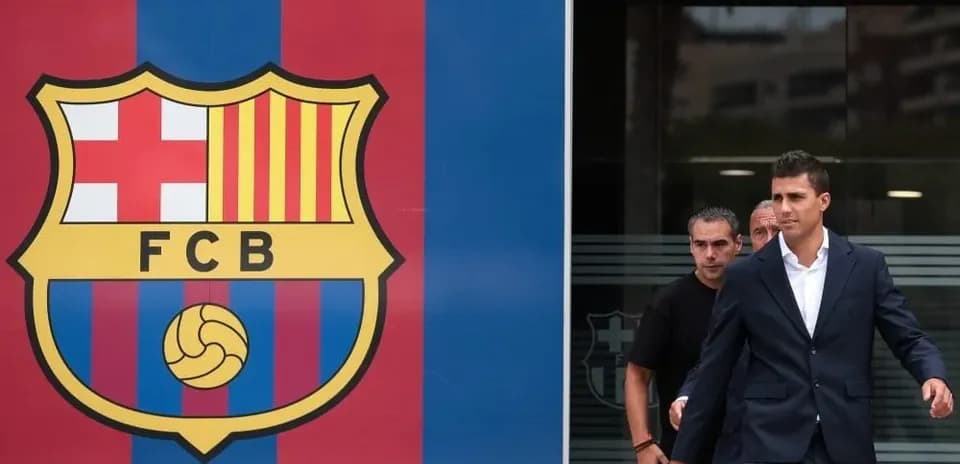 Player leaving FC Barcelona facility in formal attire