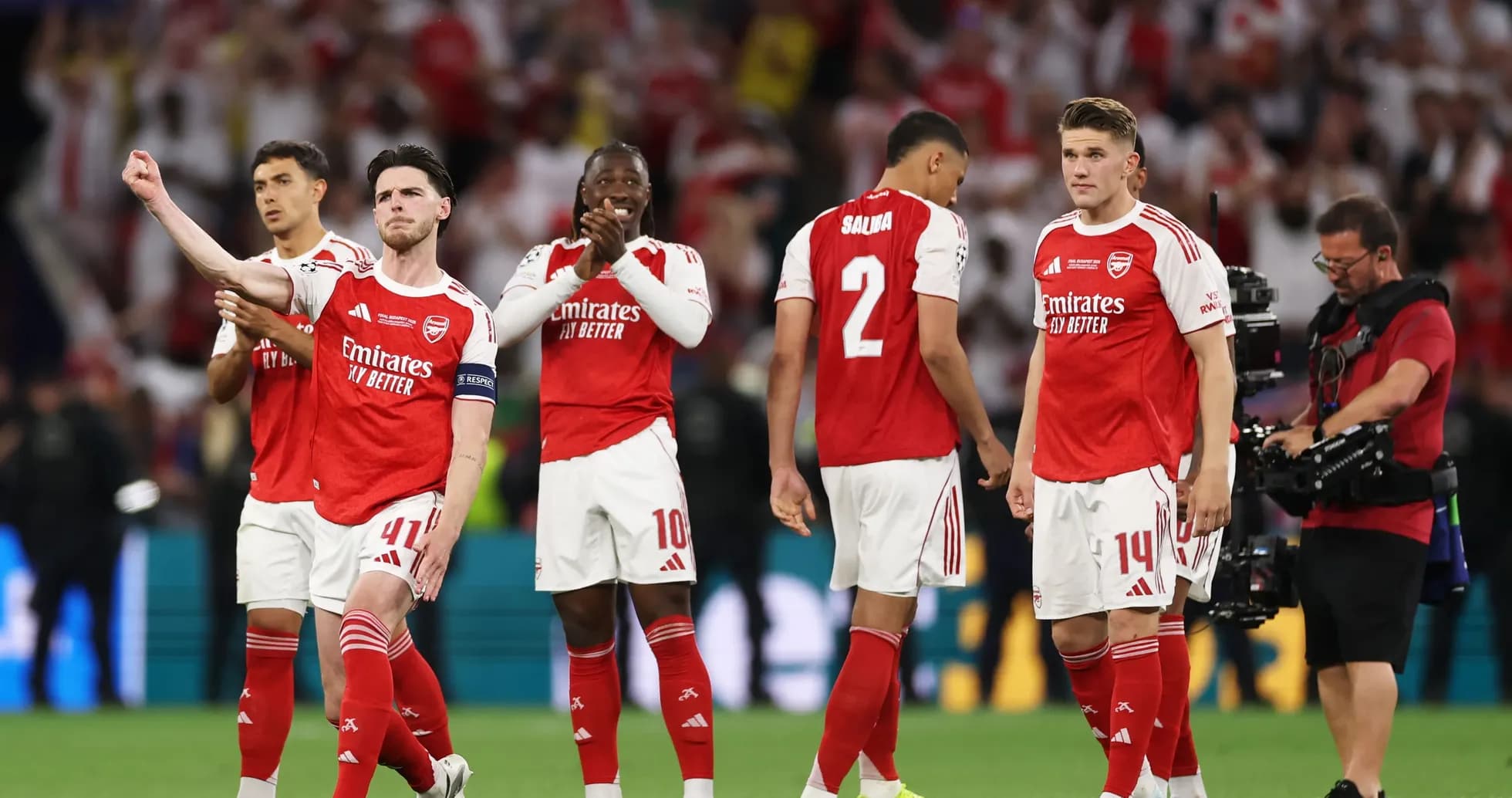 Arsenal players celebrating on the pitch after match