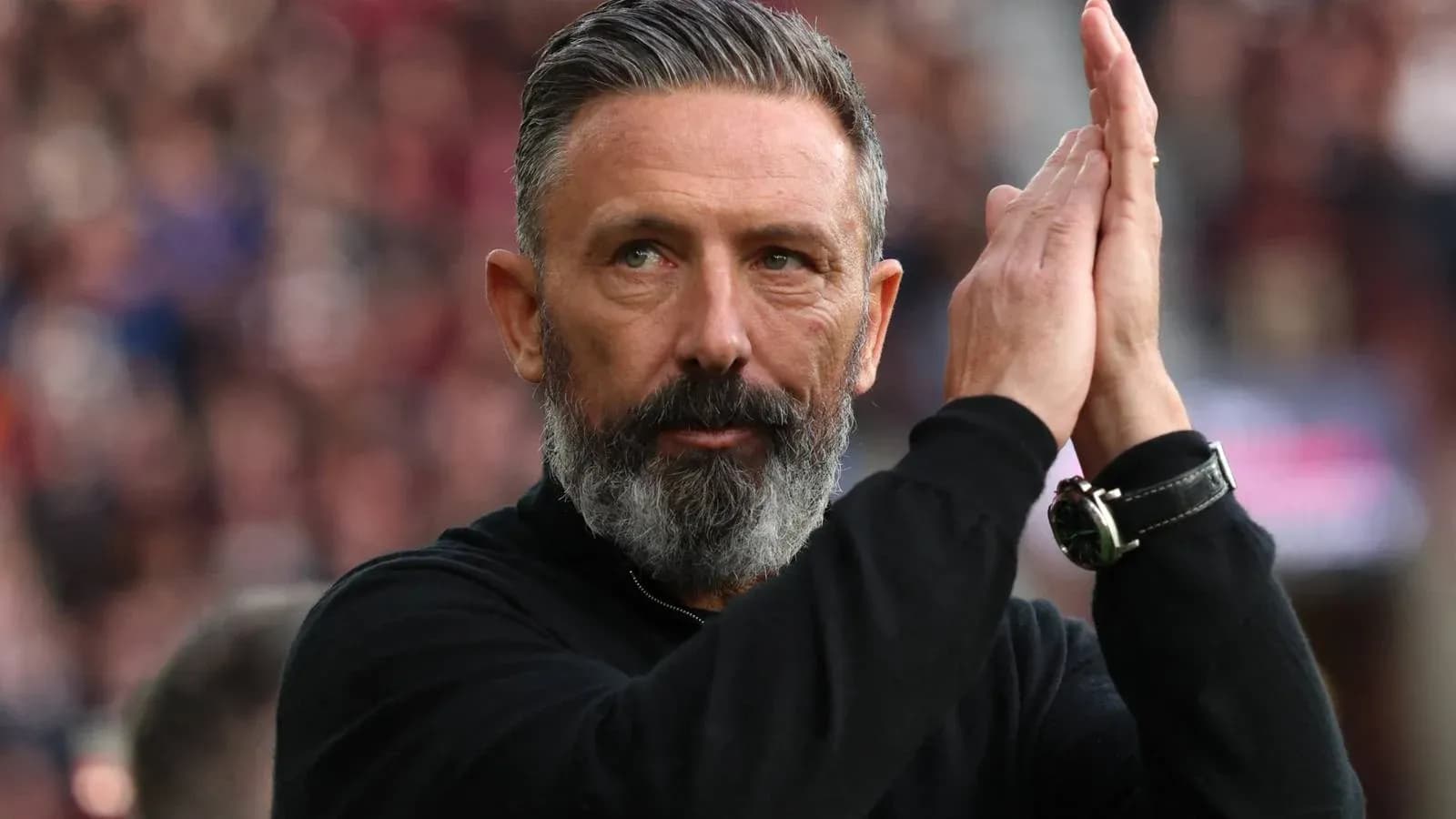 Coach applauding fans during match celebration