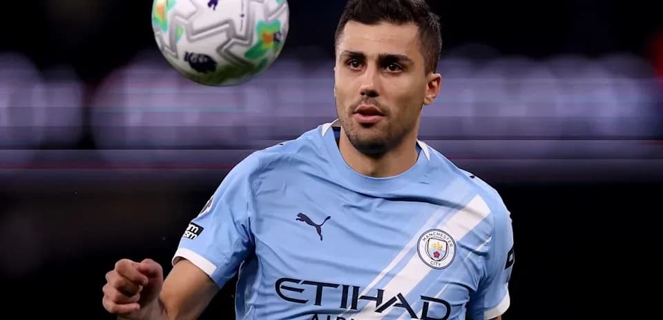Player in Manchester City kit controlling a ball