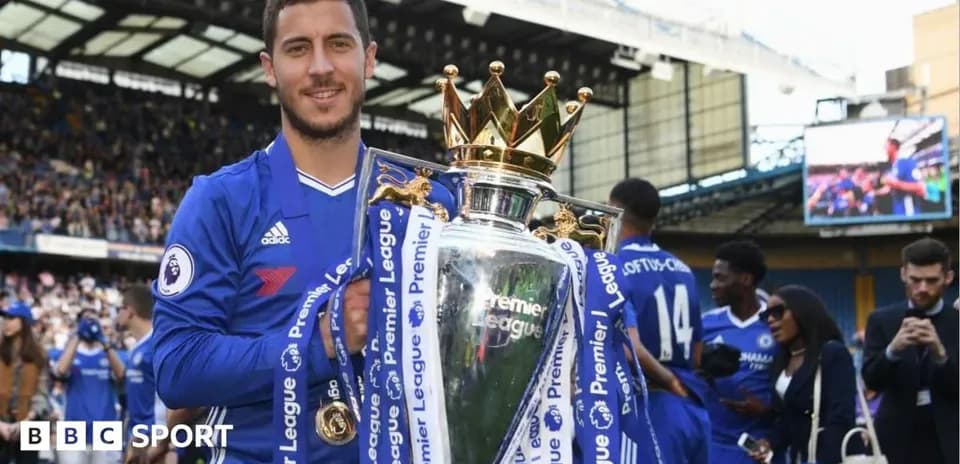 Player holding Premier League trophy in celebration