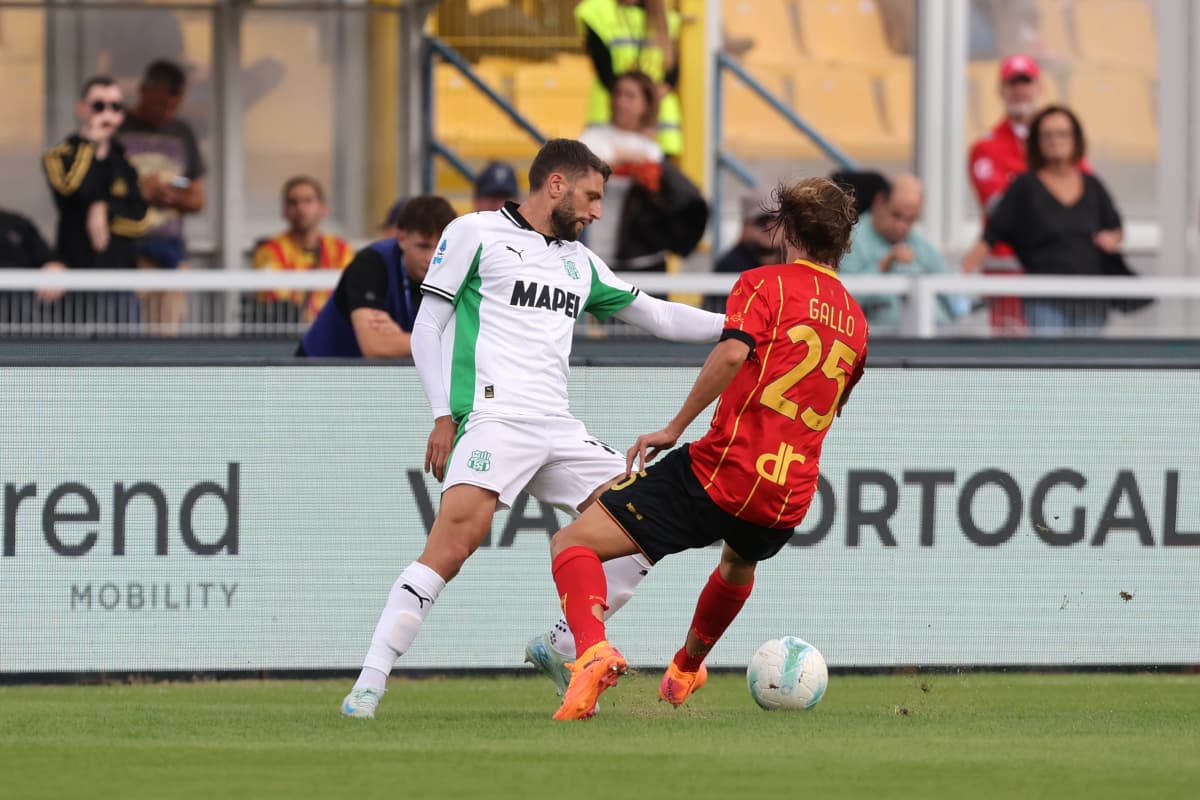 Sassuolo player challenging Lecce player for the ball
