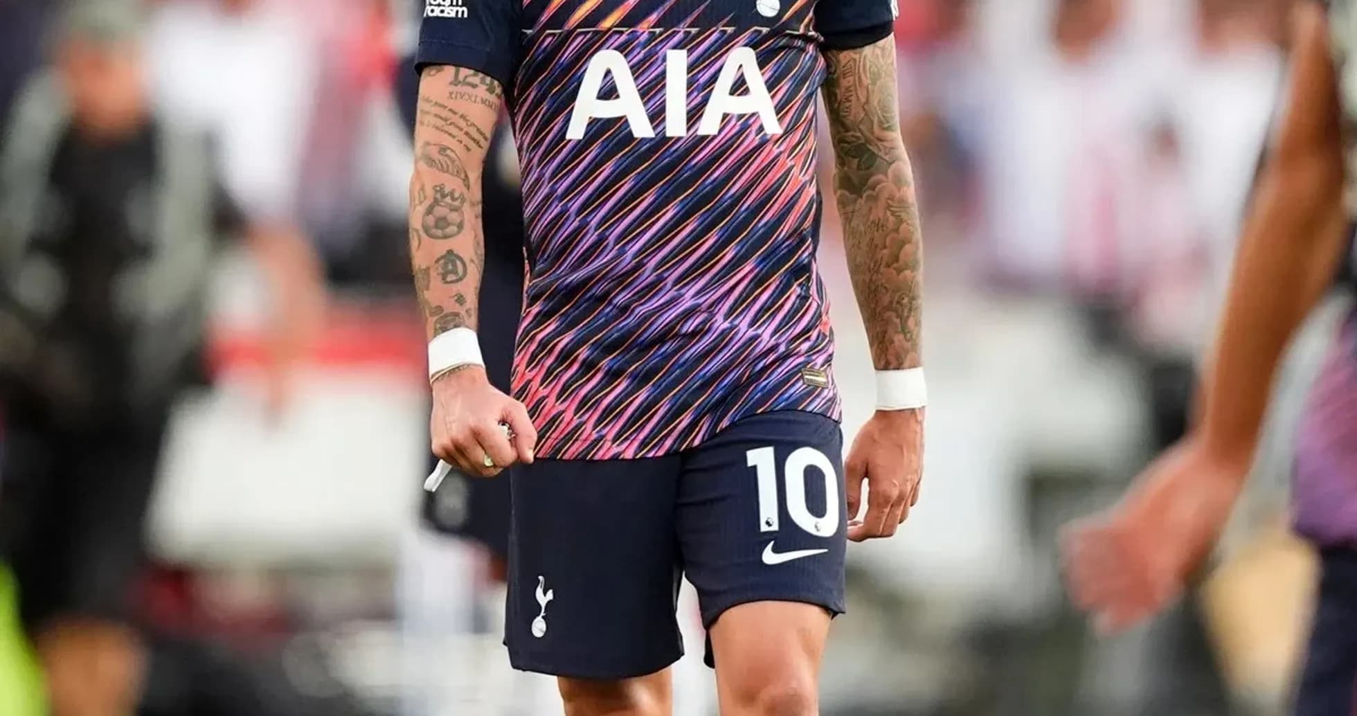 Player wearing Tottenham kit walking on the pitch