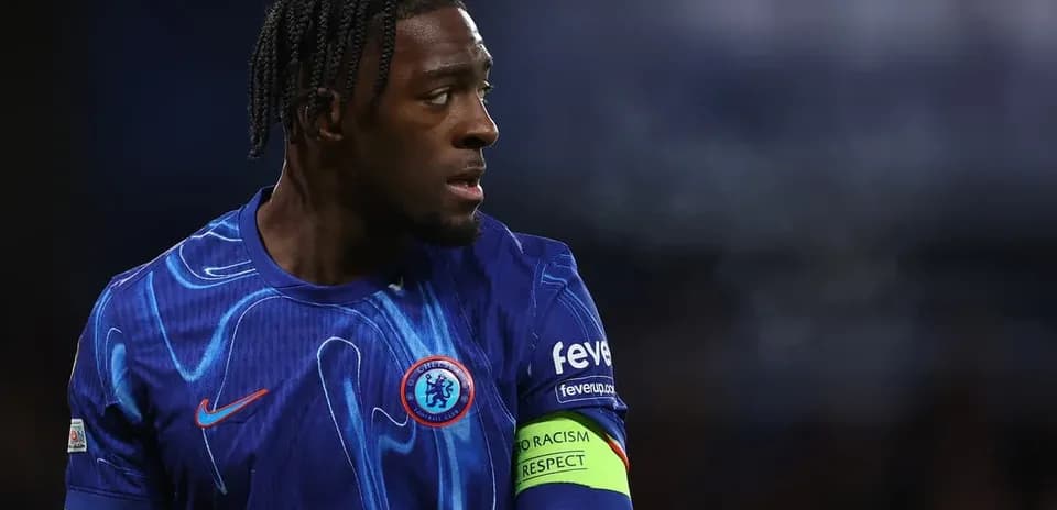 Player in blue jersey with captain's armband on field