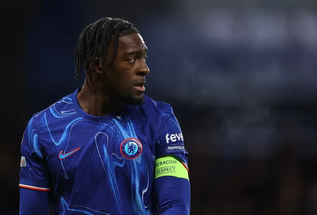 Player in blue jersey with captain's armband on field