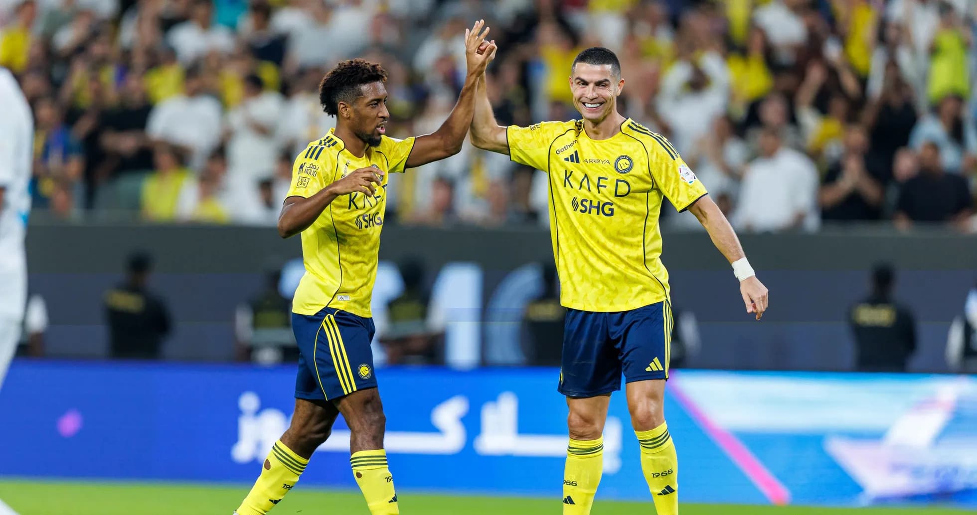 Two players celebrating a goal on the field
