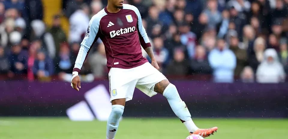 Player in Aston Villa kit preparing to kick ball