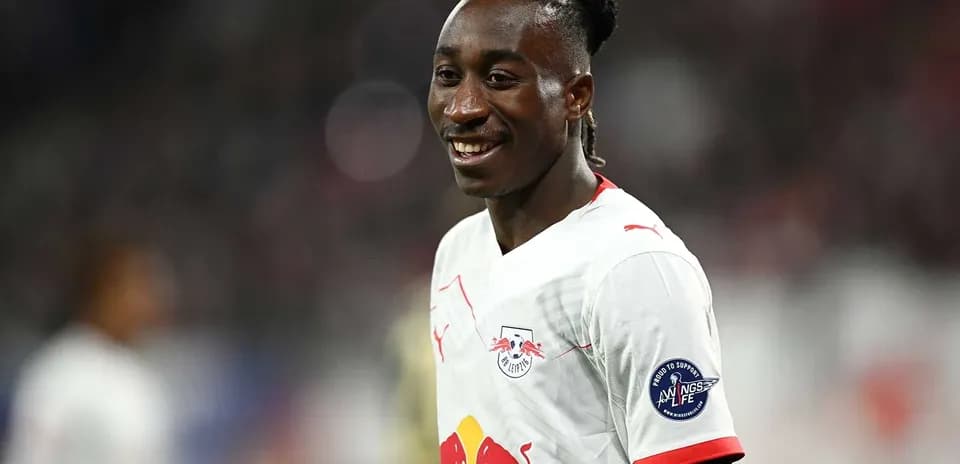 Player smiling in RB Leipzig kit on field