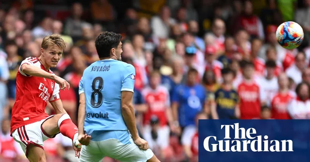 Arsenal player kicking the ball towards Kovacic