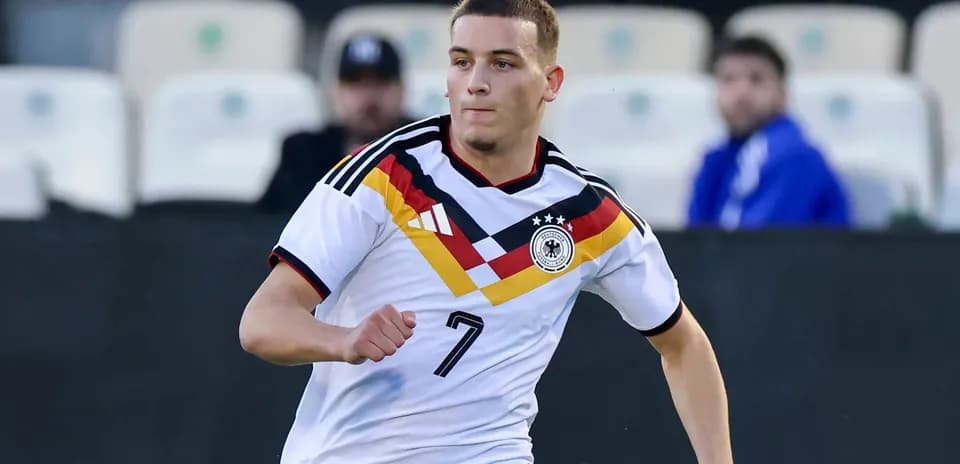 Player wearing Germany jersey running on the field