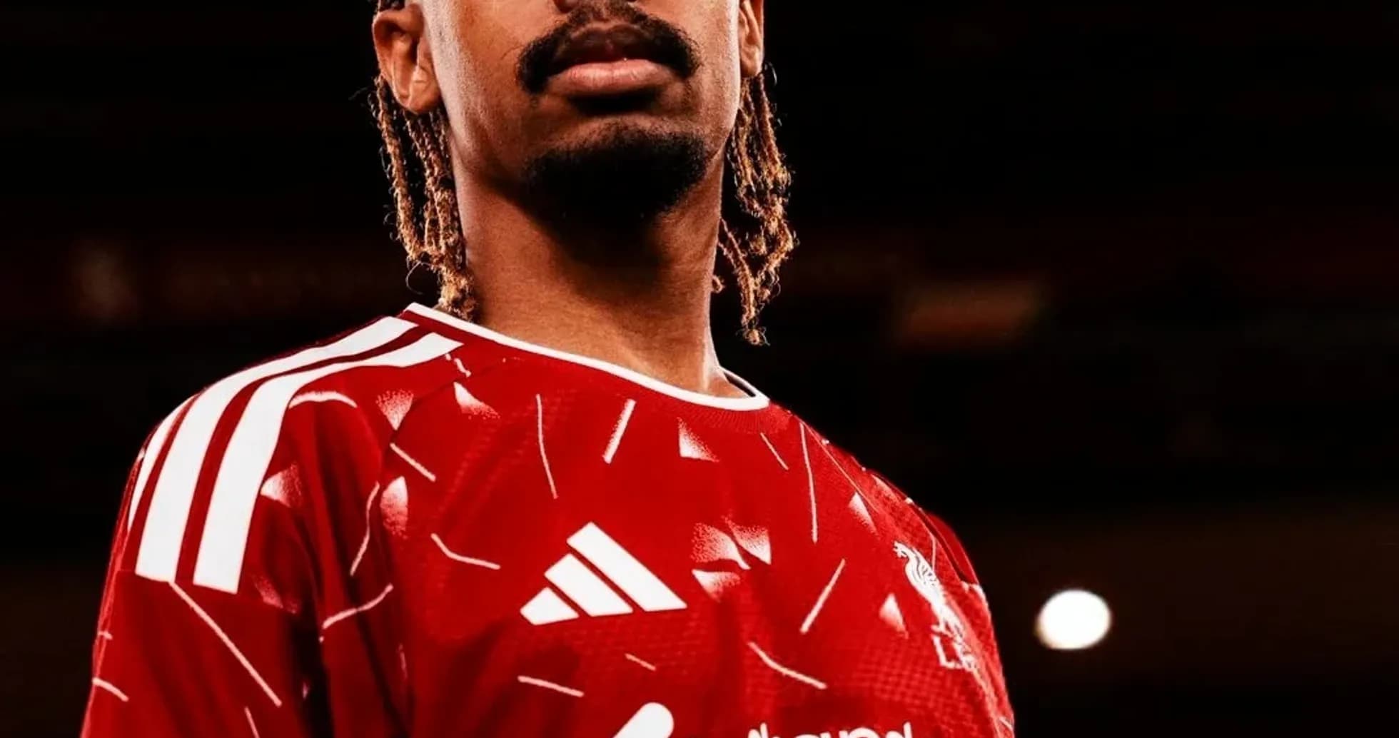 Player posing in red Liverpool jersey