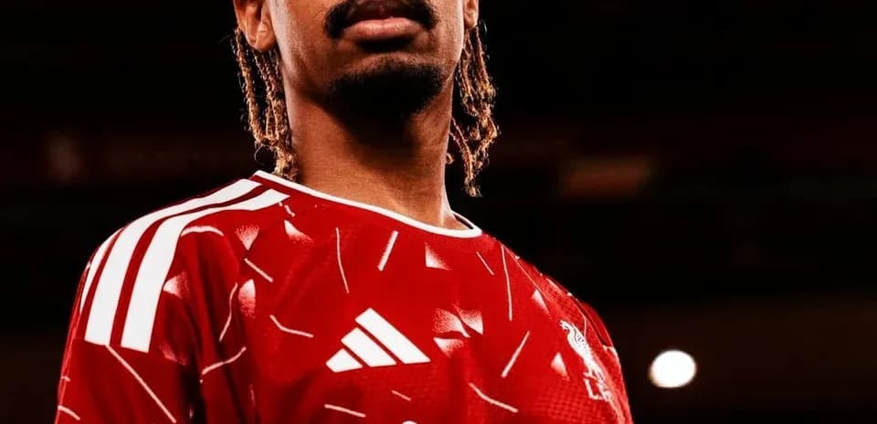 Player posing in red Liverpool jersey