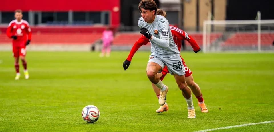 Player dribbling the ball during MLS Next Pro match