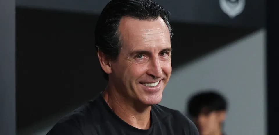 Coach smiling during a match on the sidelines