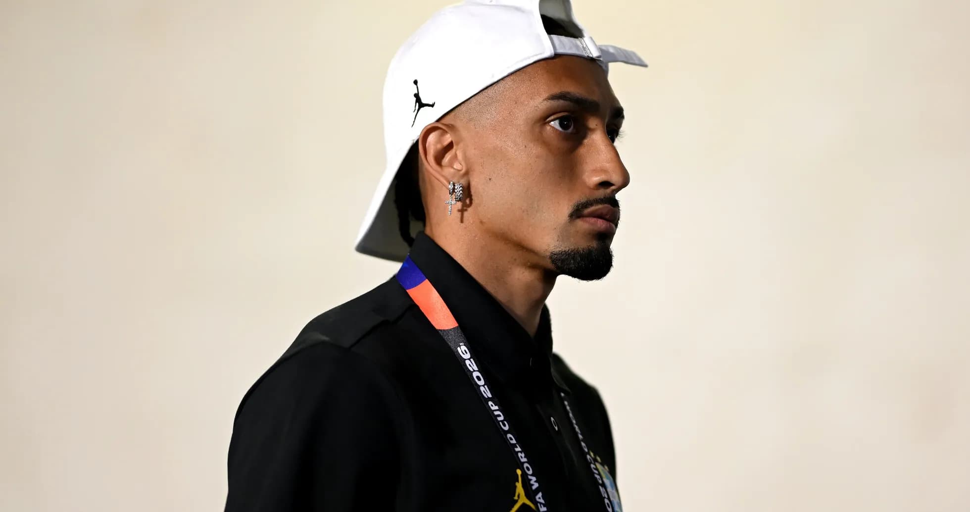 Person wearing cap and lanyard in profile