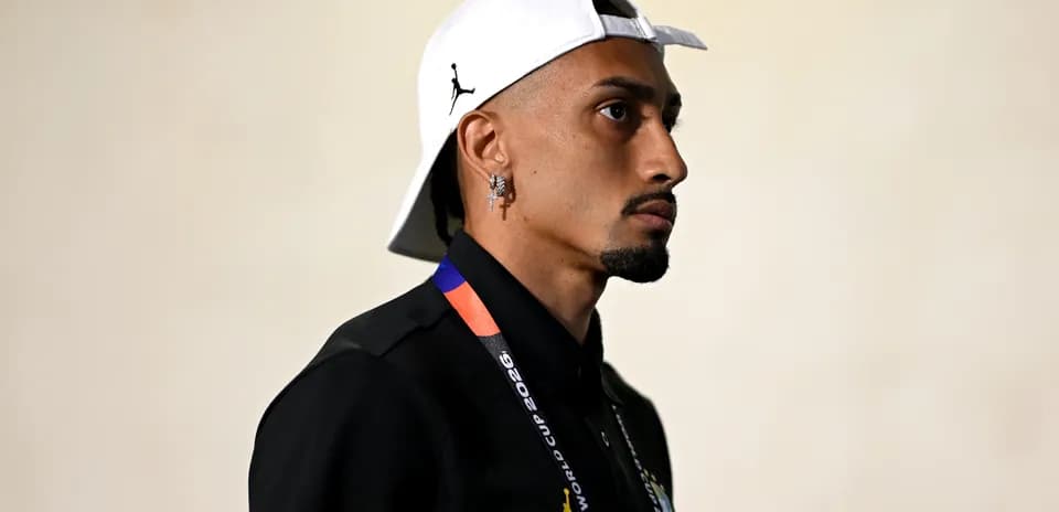 Person wearing cap and lanyard in profile