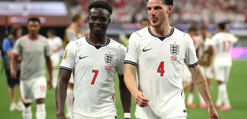 Two England players walking off the field after match