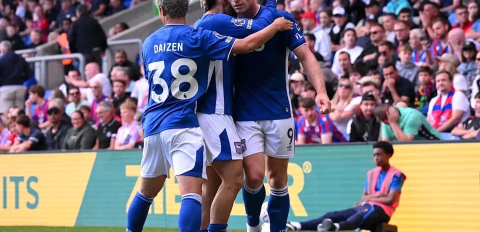 Players celebrating a goal on the field