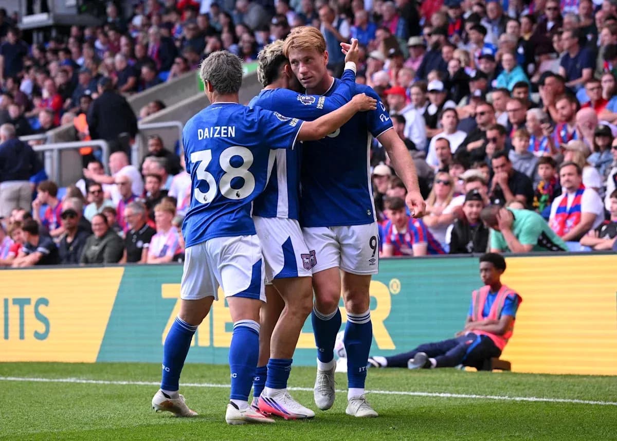 Players celebrating a goal on the field