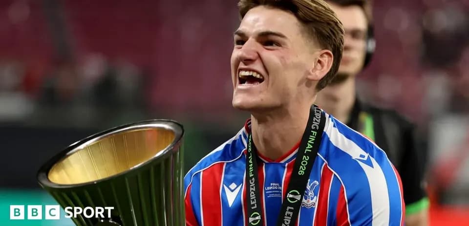 Player celebrating with trophy after winning final