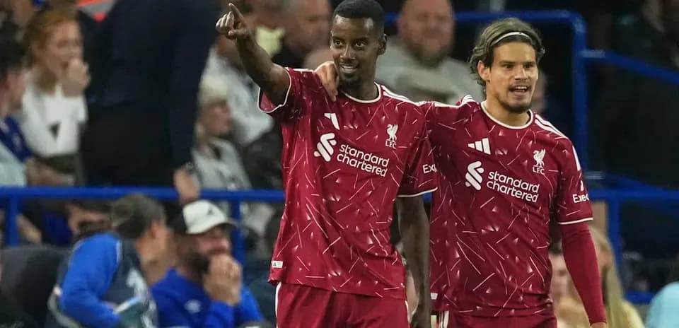 Two Liverpool players celebrating a goal together