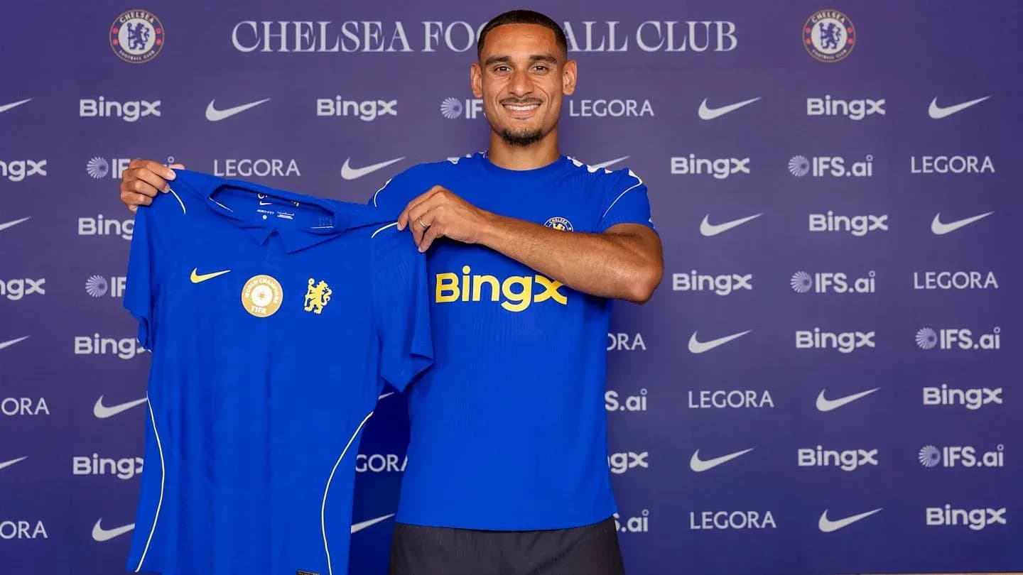 Player holding Chelsea jersey at announcement event