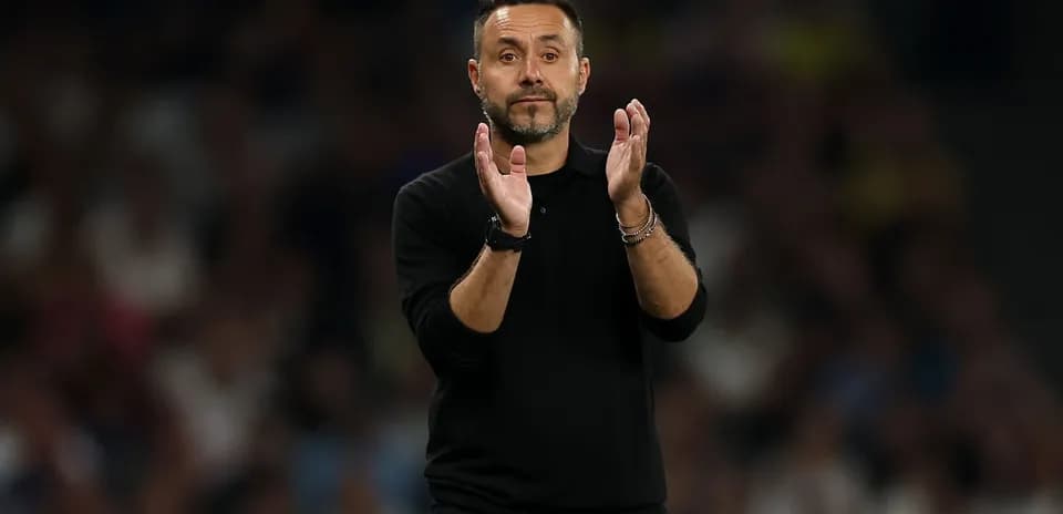 Coach applauding during a football match
