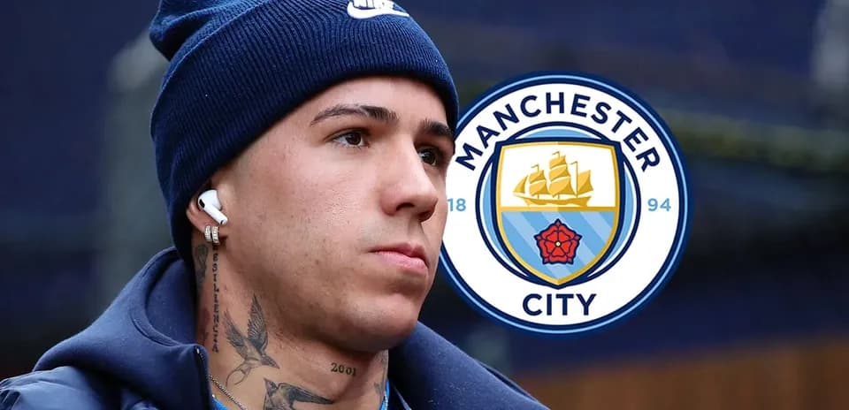 Player with headphones near Manchester City logo