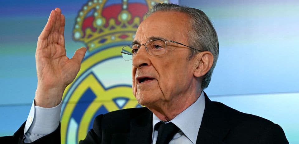 Official speaking at press conference with Real Madrid logo