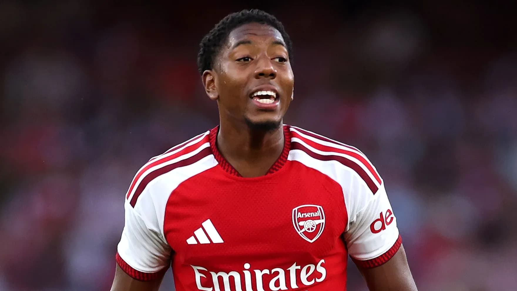 Player celebrating in Arsenal jersey during match