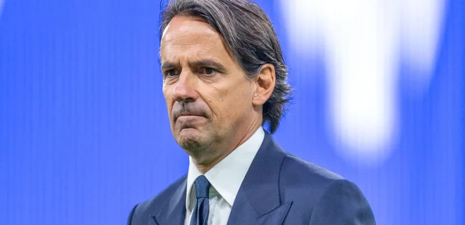 Coach standing in front of a blue backdrop