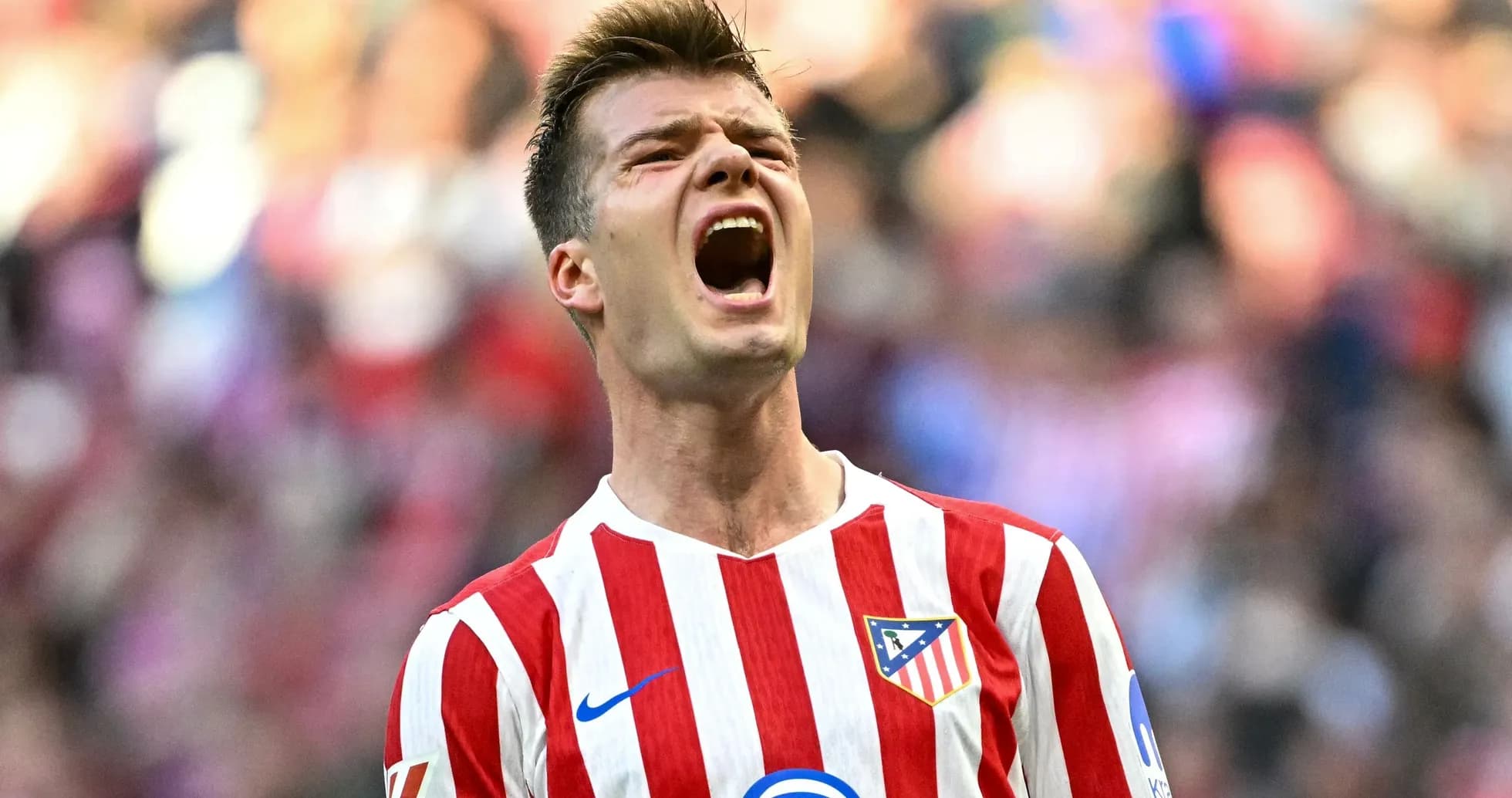 Player celebrating with Atletico Madrid jersey