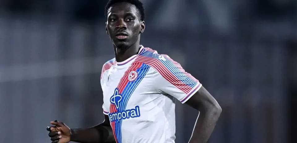 Player in white jersey running during a match