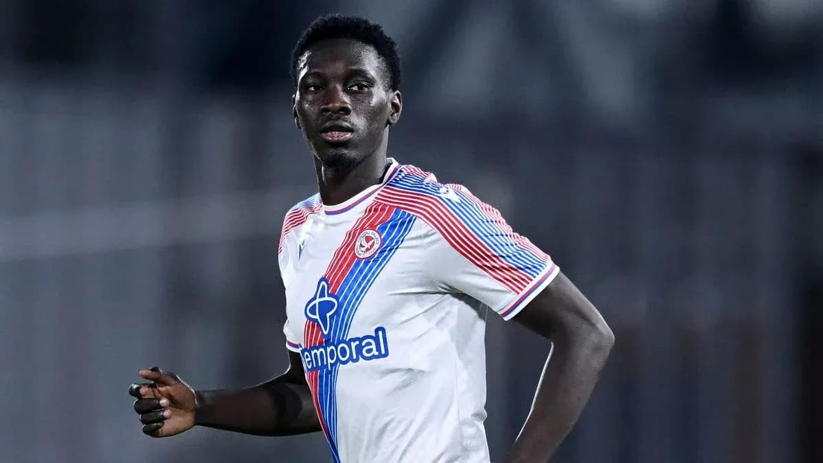 Player in white jersey running during a match