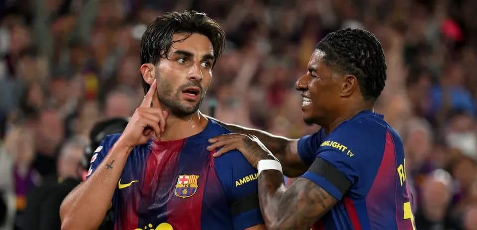 Two FC Barcelona players celebrating on the pitch
