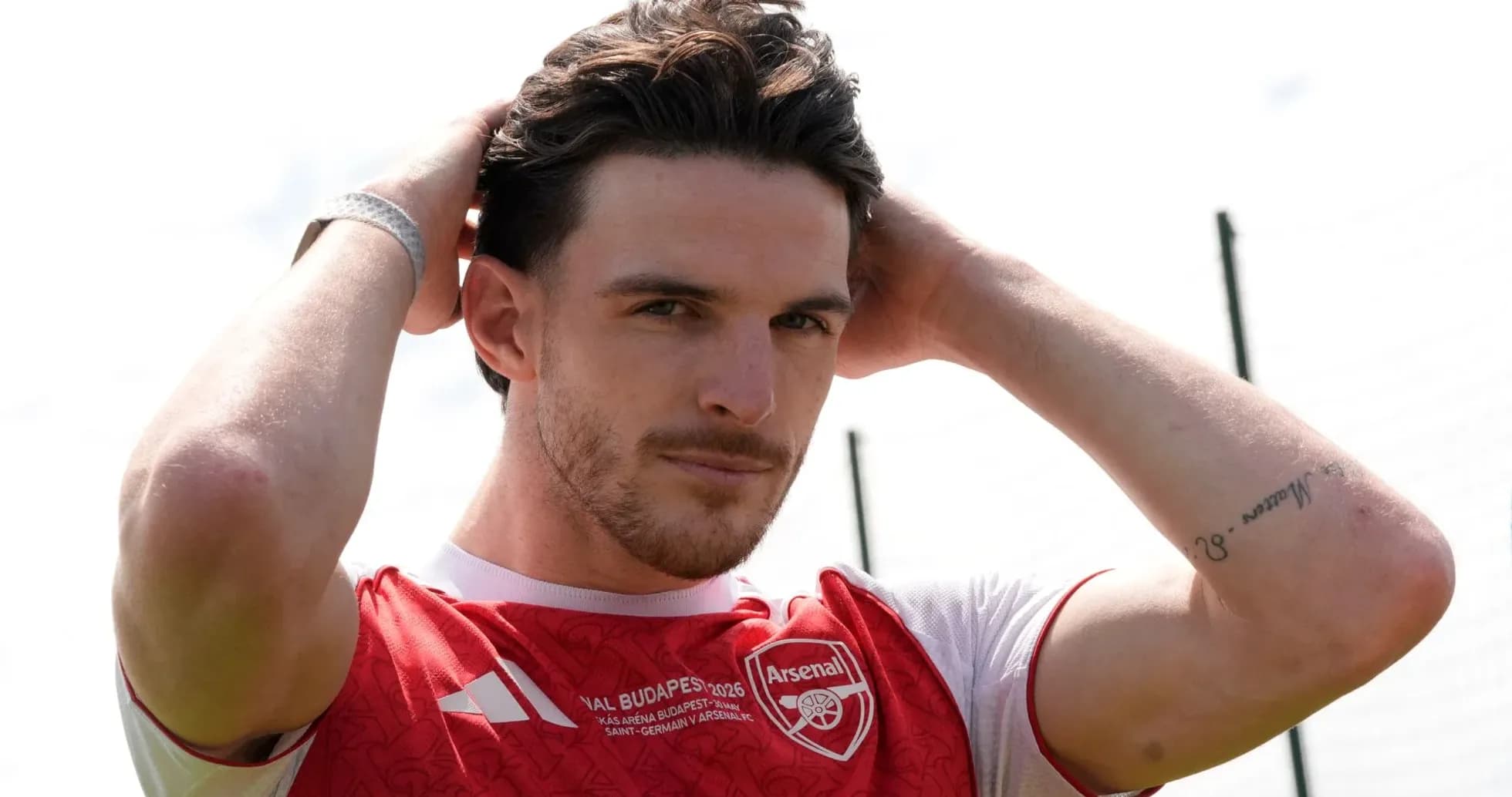 Player adjusting hair in Arsenal training kit