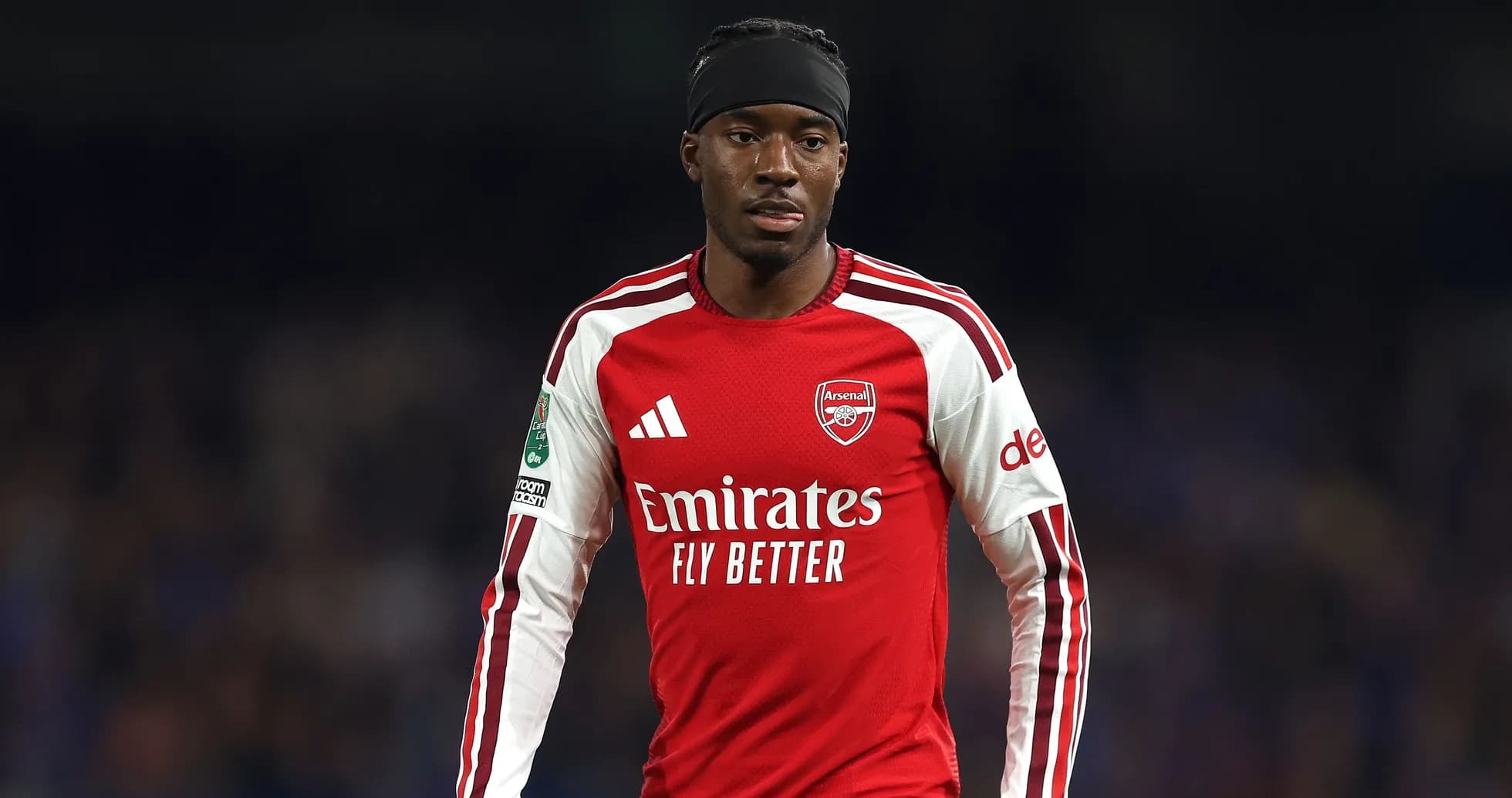 Arsenal player in red kit during match