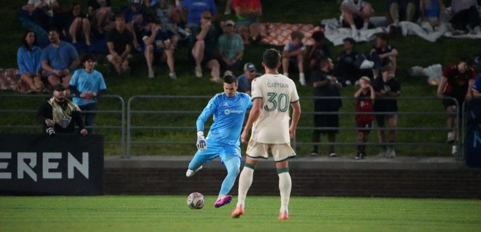 Goalkeeper prepares to kick the ball during match