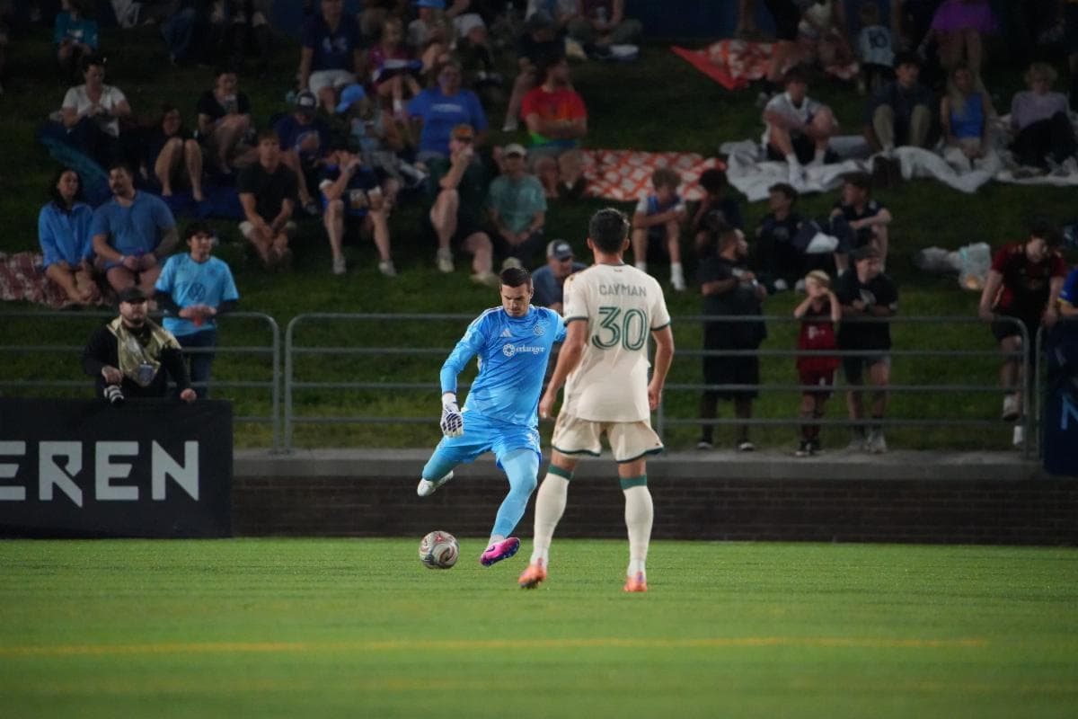 Goalkeeper prepares to kick the ball during match